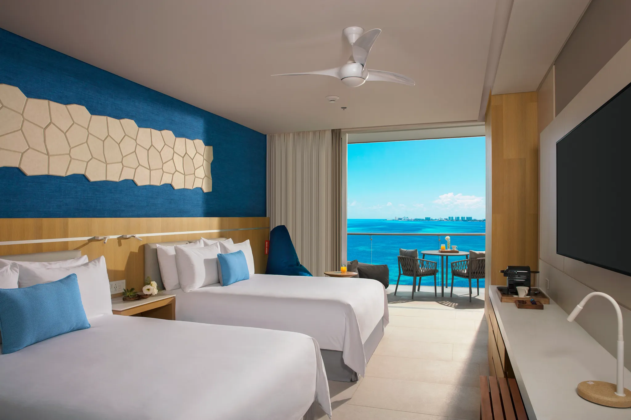 Deluxe Family Suite Ocean View with two double beds and private balcony overlooking the Caribbean at Dreams Vista Cancun.