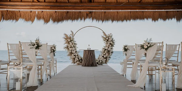 Ocean Deck Palapa thatched-roof beachfront wedding setup at Dreams Vista Cancun Golf & Spa Resort