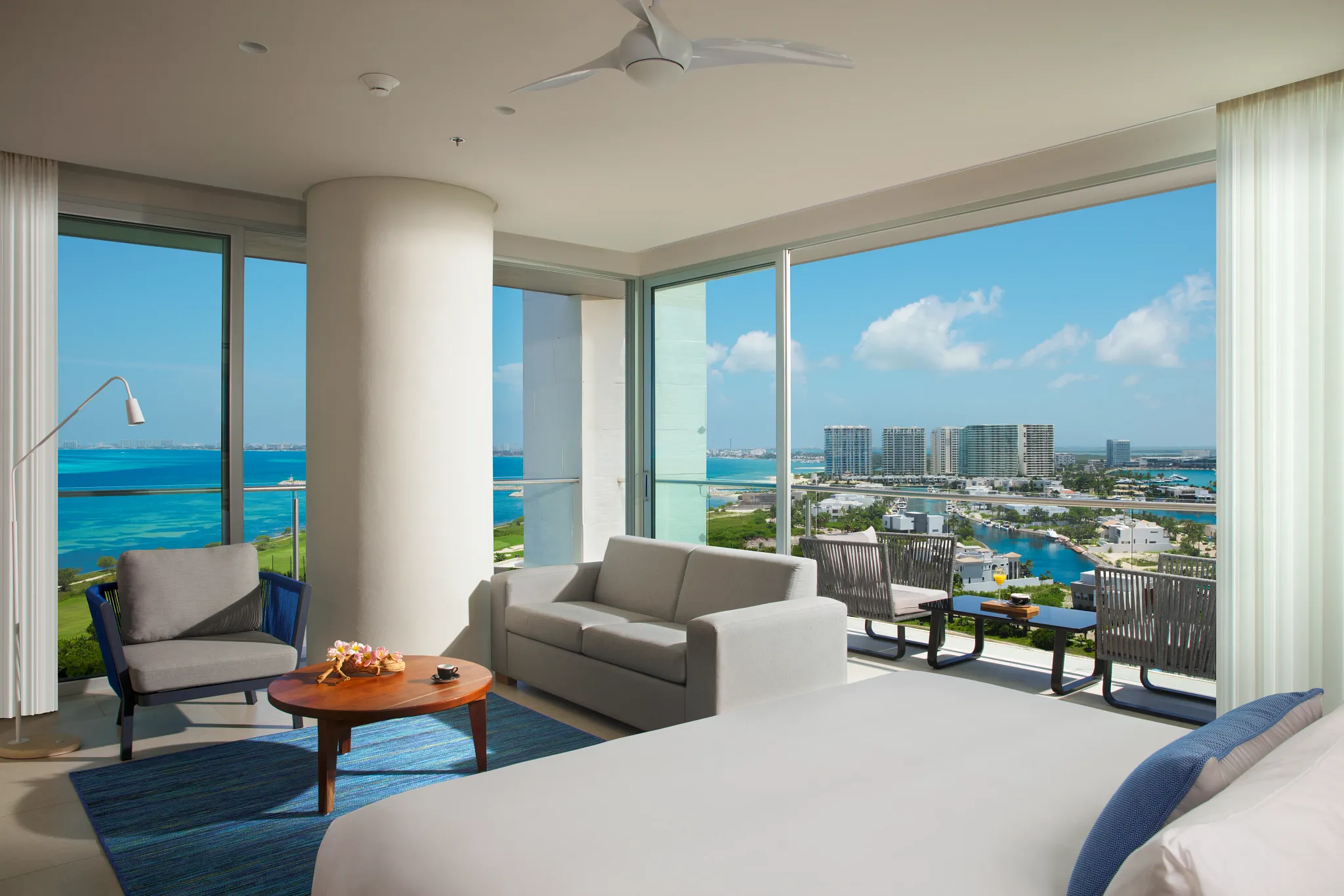 Preferred Club Corner Suite Ocean View with king bed, living area, and wraparound windows at Dreams Vista Cancun.