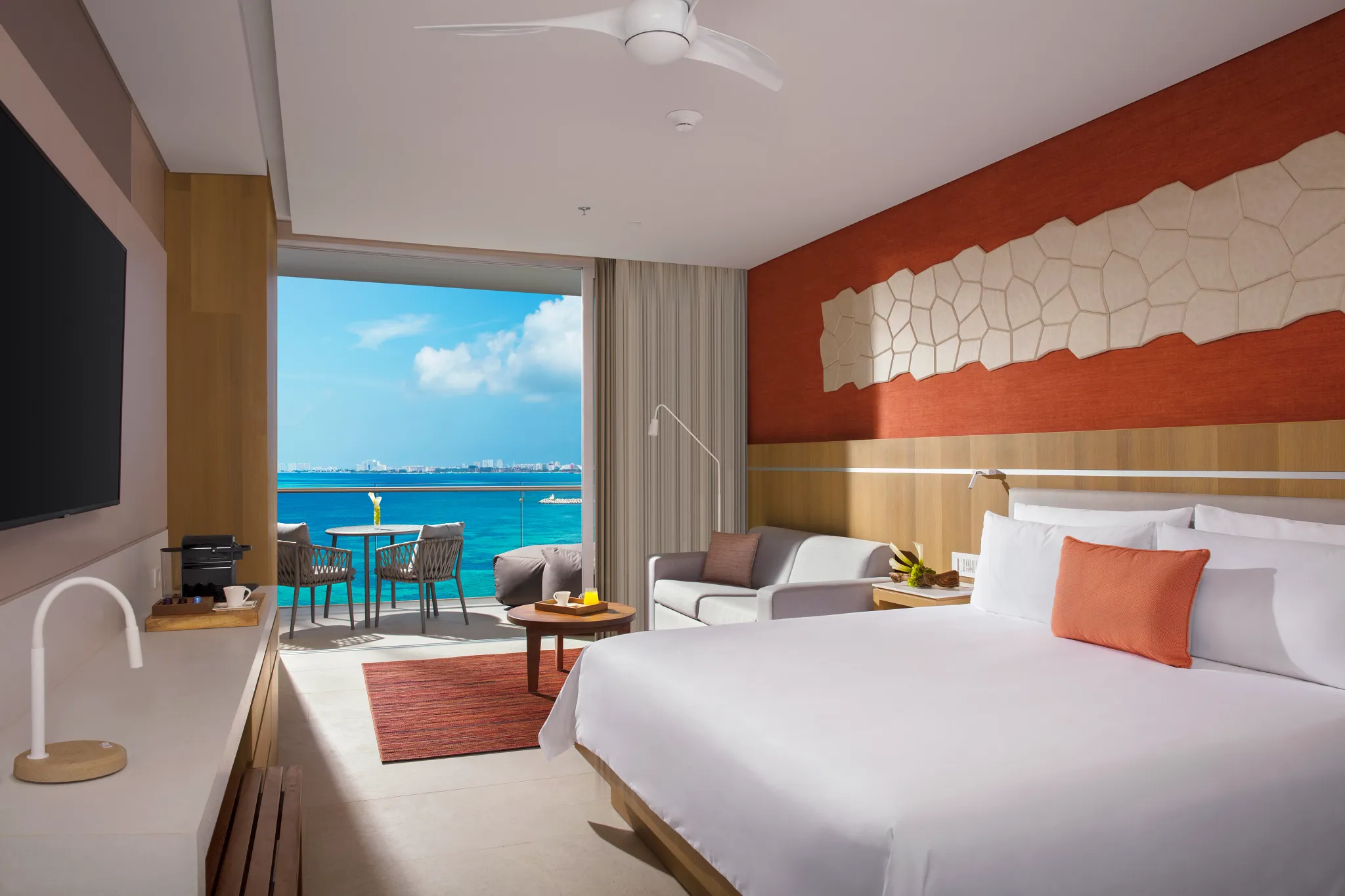 Preferred Club Deluxe Ocean View room with king bed, modern décor, and private balcony overlooking the Caribbean at Dreams Vista Cancun.