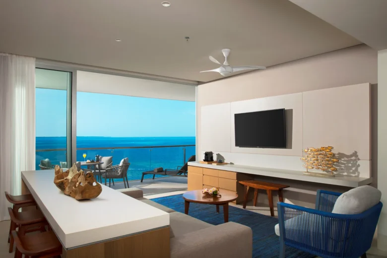 Preferred Club Master Family Suite Ocean View living area with sofa, kitchenette, and balcony overlooking the Caribbean at Dreams Vista Cancun.