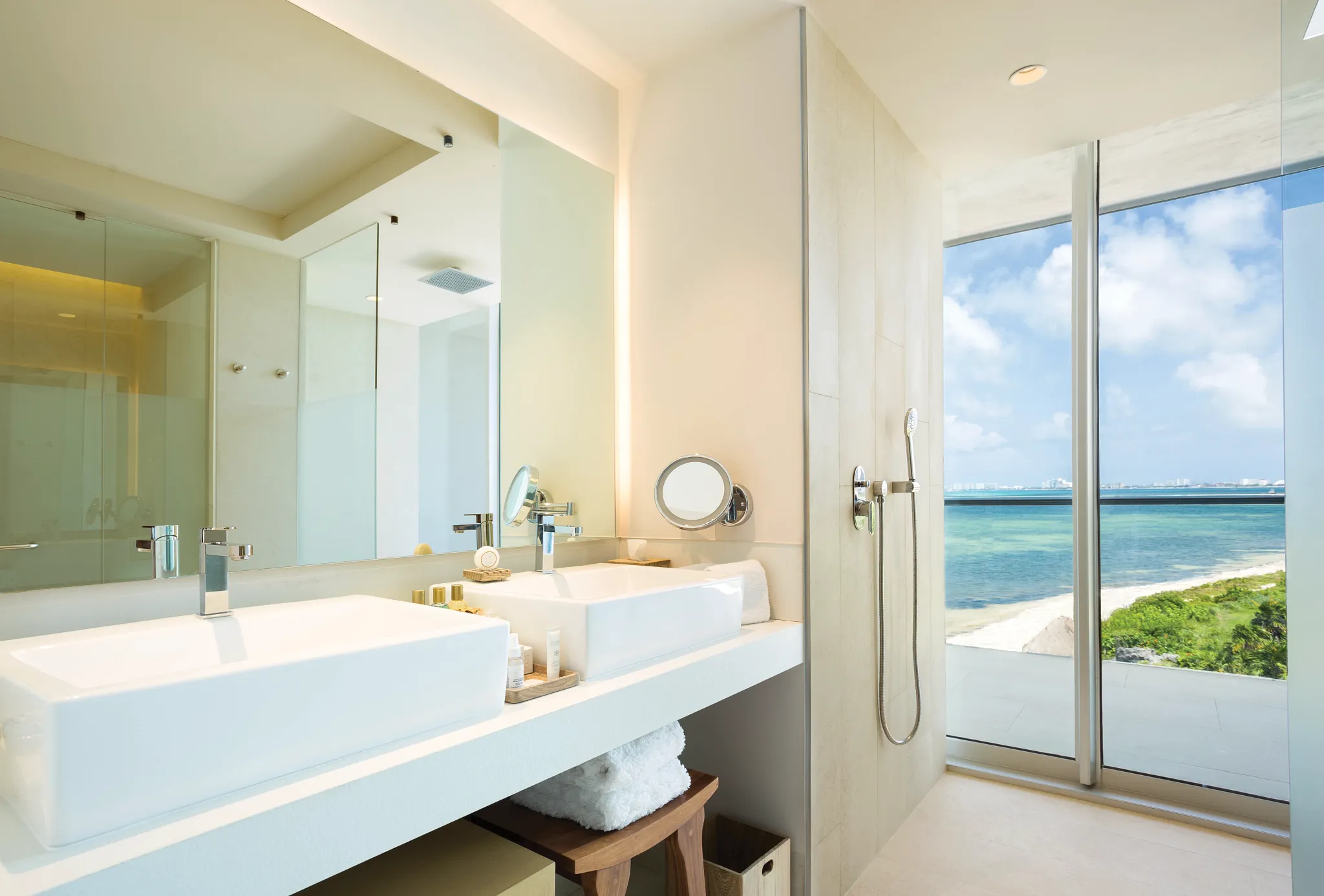 Preferred Club Master Suite Ocean Front bathroom with double sinks and ocean view shower at Dreams Vista Cancun.