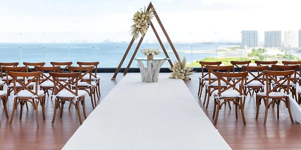 Preferred Deck oceanfront wooden ceremony setup for weddings at Dreams Vista Cancun Golf & Spa Resort