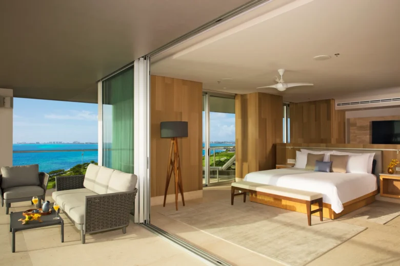 Presidential Suite Ocean Front bedroom with king bed and private terrace overlooking the Caribbean at Dreams Vista Cancun.