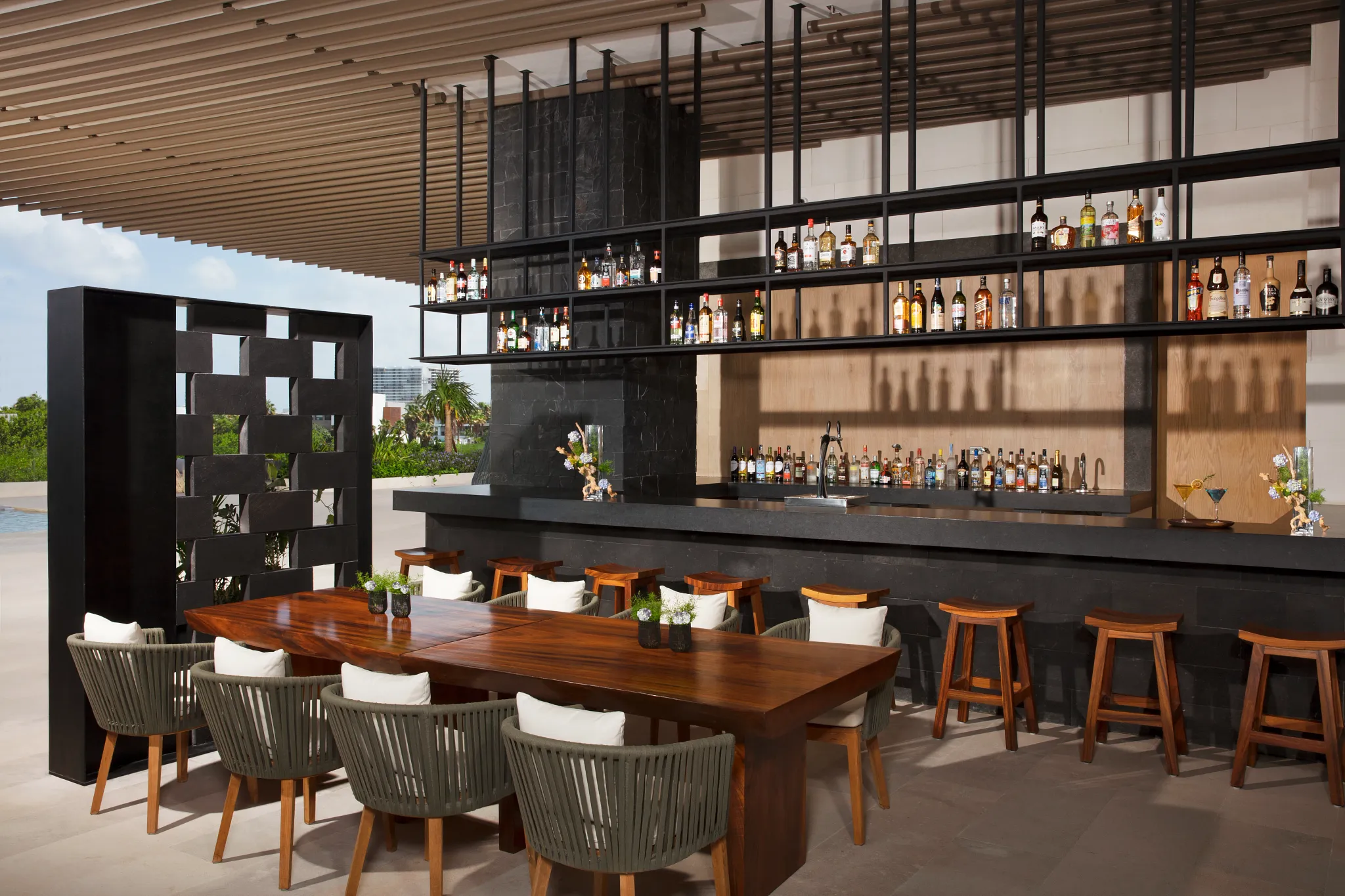 Veranda bar at Dreams Vista Cancun featuring an open-air terrace lounge, casual seating, and refreshing drinks near La Plaza gourmet court.