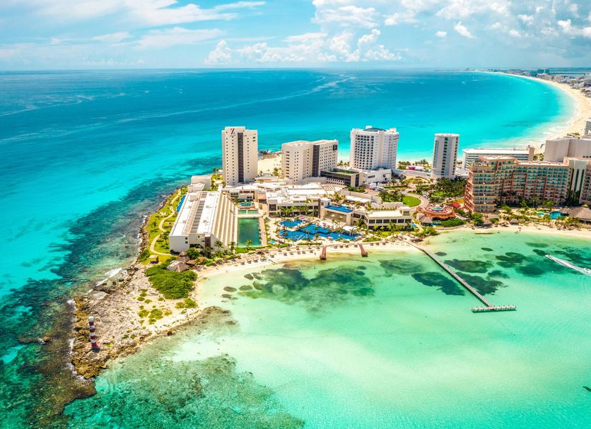 Hyatt Ziva Cancun all-inclusive resort with oceanfront infinity pools, white sand beach, and turquoise Caribbean waters in Cancun's Hotel Zone.
