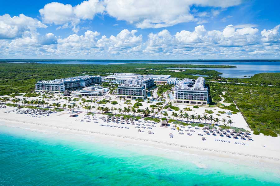 Majestic Elegance Costa Mujeres luxury all-inclusive resort with expansive pools, beachfront setting, and grand architecture.