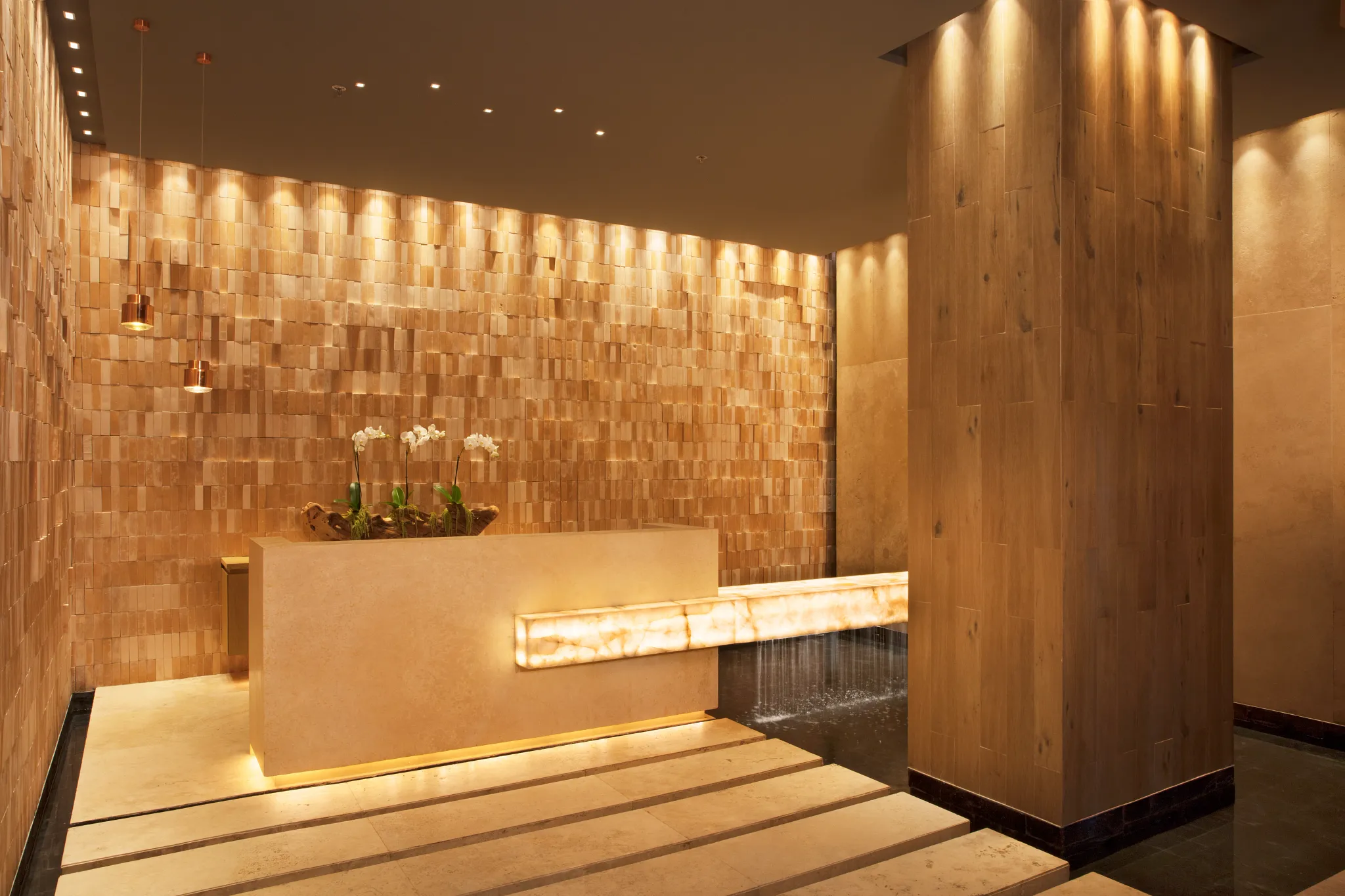 Elegant spa reception with warm lighting and water feature at Dreams Vista Cancun Golf & Spa Resort.
